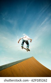 Skater In Jump Over Skating Ramp