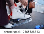 Skater prepares for a session on ice during winter festivities in a rink