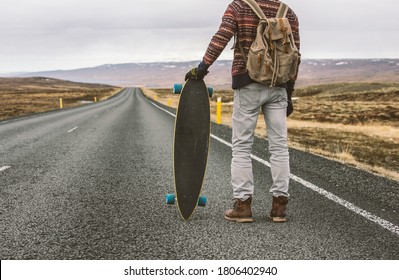 Skater traveling iceland on his longboard