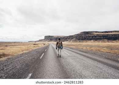 Skater traveling iceland on his longboard. Young man making an adrenaline-filled experience between the lands. - Powered by Shutterstock