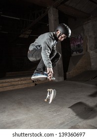 Skater Wearing Helmet Doing 360 Trick In The Skate Park