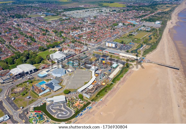 Skegness\
UK, 21st May 2020: Aerial photo of the town centre of Skegness\
showing the pier on the sandy beach near fairground rides in the\
East Lindsey district of Lincolnshire,\
England
