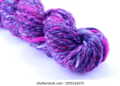 Skein Of Hand Spun Yarn In Pink, Red, Grey, Purple, And Red - With White Background