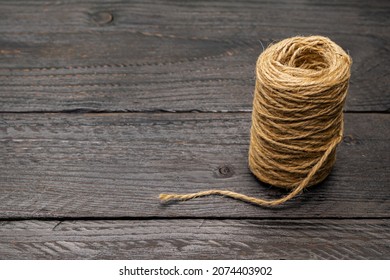 A Skein Of Rope On A Dark Wooden Table