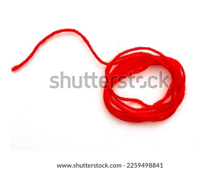 Skein of thin red string or rope isolated on white, top view