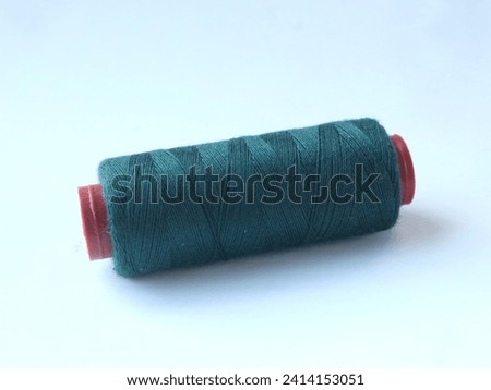 Skein of thread filled dark blue color isolated on white background.