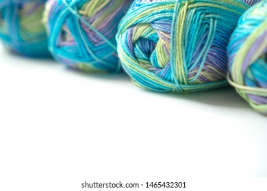 Skeins multi  colored gradient yarn for knitting children's clothes white background  Gentle multicolor yarn blue  green  violet color  For yarn  fabric stores  for design banners  flyers 