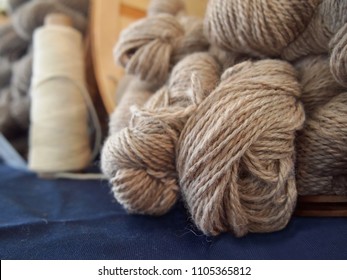 Skeins Of Natural Colored Handspun Sheep Wool Yarn In A Basket At An Agricultural Fiber Festival.