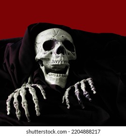 Skeleton In Black Cloak On Blood Color Background, Halloween Concept