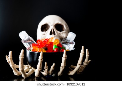 Skeleton Claw Hands With Candy And Hand Sanitizer - Halloween Concept