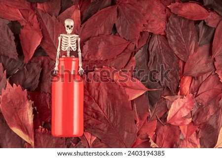 the skeleton climbs out of a red vase, the background is red autumn leaves. the gin that came out of the bottle