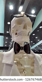 Skeleton dressed in a white jacket with bow tie