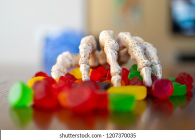 Skeleton Hand With Bowl Of Candy During Halloween