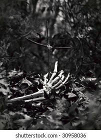 Skeleton Hand Coming Out Of The Ground, Reaching For A Crudely Made Cross