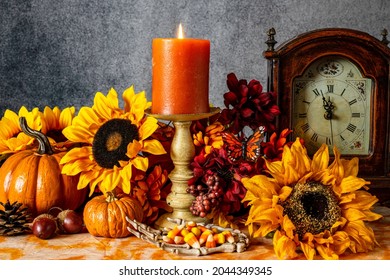 Skeleton Hand Filled With Candy Corn With Sunflowers Pumpkins Butterfly And Burning Candle