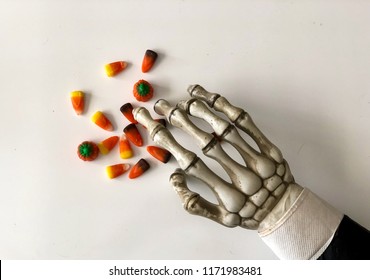 Skeleton Hand Reaching For Candy Corn Mix