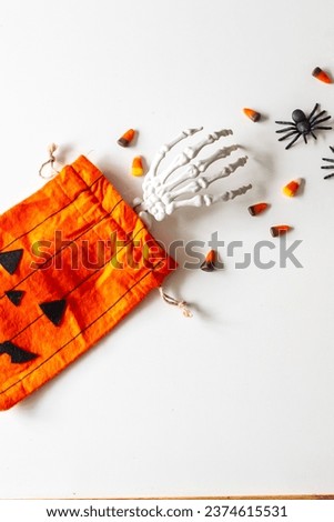 Skeleton hand reaching for candy corn and spiders