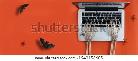 Skeleton hands typing in laptop