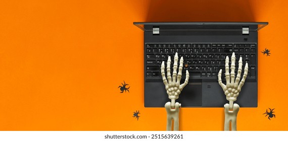 Skeleton hands working on laptop, spiders nearby. Halloween concept. - Powered by Shutterstock