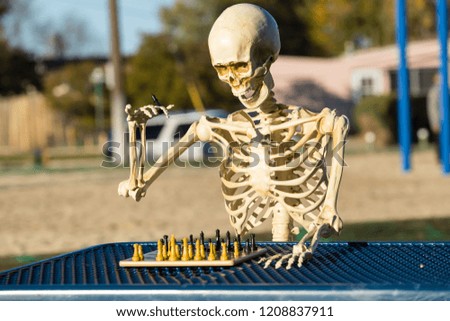 Skeleton makes a move with his king on the chess board