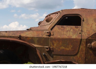 The Skeleton Of An Old Ruined Armored Car In A War Zone
