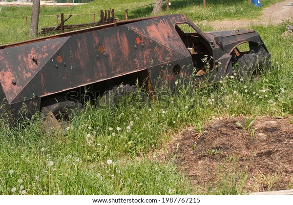 The\
skeleton of an old ruined armored car in a war\
zone\

