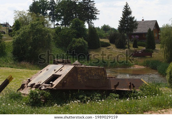 The skeleton of an old ruined military tank in a\
war zone\
