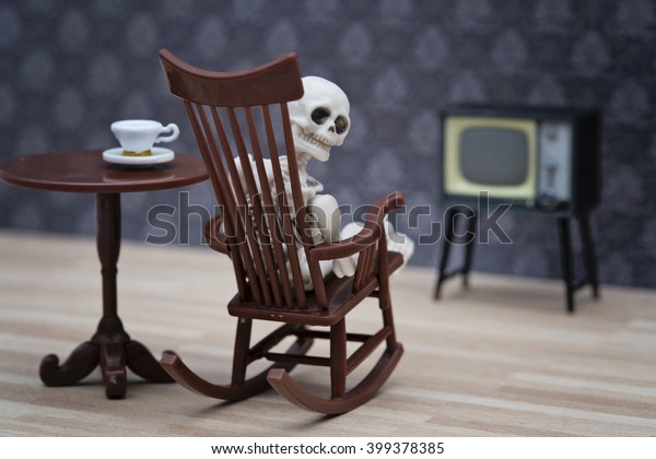 Skeleton On Rocking Chair Looking Back Royalty Free Stock Image