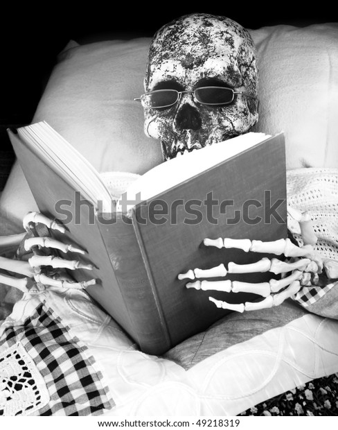 skeleton-reads-bed-600w-49218319.jpg