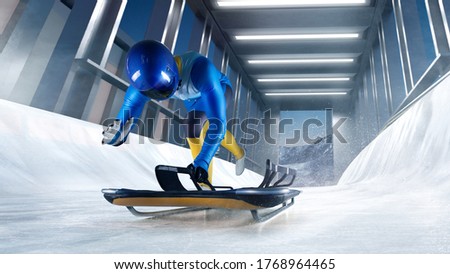 Skeleton sport. Bobsled. Luge. The athlete descends on a sleigh on an ice track. Winter sports.
