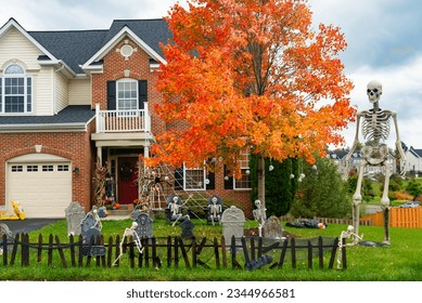 Skeletons, pumpkins and skulls are traditional attributes of Halloween in America. Frontyard decoration for Halloween party. - Shutterstock ID 2344966581