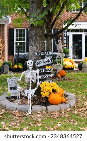 Skeletons, pumpkins and skulls are traditional attributes of Halloween in America. Frontyard decoration for Halloween party. - Shutterstock ID 2348364527