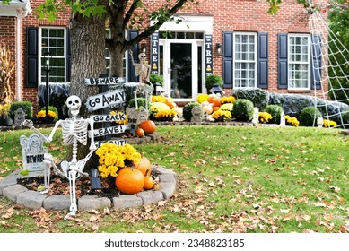 Skeletons, pumpkins and skulls are traditional attributes of Halloween in America. Frontyard decoration for Halloween party.Space for text. - Shutterstock ID 2348823185