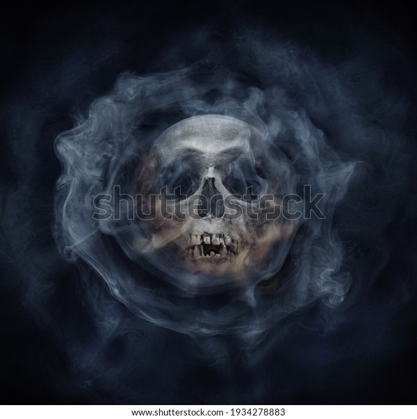 A\
skeleton\'s skull and smoke. Horror stories,  phantom,  apparition,\
wraith, spook phantasm background. Old gothic\
style.