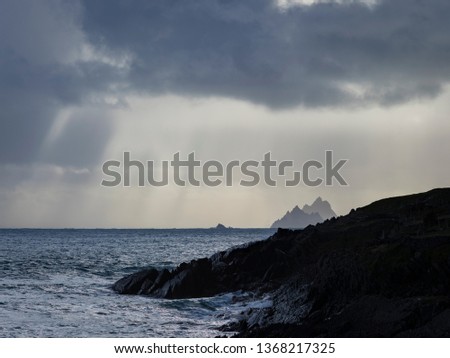 skellig michael off the coast of the ring of kerry in winter showing deep blue waters and crashing waves