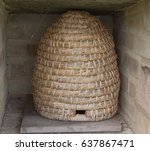 Skep Beehive Next to an Orchard on a Farm Near the Village of Studley Roger in Rural Yorkshire, England, UK