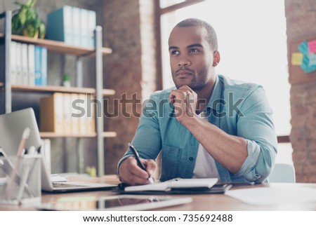 Skeptic, unsure, uncertain, doubts concept. Young african student is making decision sitting at the office in casual smart