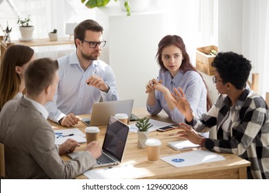Skeptical Caucasian Colleagues Listen To African Employee Intern Tell Opinion Bad Idea At Group Meeting, Incompetent Black Employee Speaking At Diverse Briefing, Racial Discrimination At Work Concept