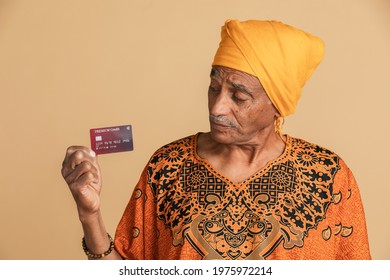 Skeptical mixed Indian man holding a credit card