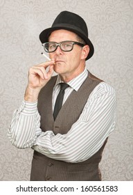 Skeptical white businessman with hat smoking a cigarette