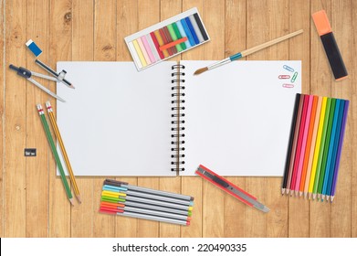 Sketch Book And Paint Tools On Wood Background