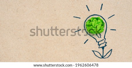 Sketch of glowing green crumpled paper light bulb, Corporate Social Responsibility (CSR), eco-friendly business and environmental concept with copy space