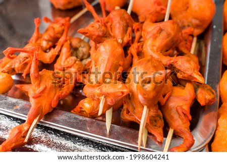 Skewered deep fried One day old chicks, an exotic Filipino street food.