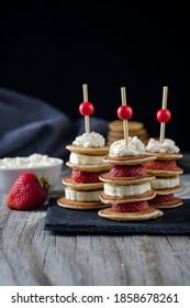 Skewers With Mini Pancakes, Strawberries, Banana And Ricotta On A Dark Background