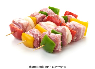 Skewers with pieces of raw meat, red, yellow and green bell pepper, seasoned with coarse salt and olive oil, isolated on white background. Close-up. - Powered by Shutterstock