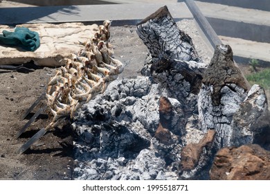 Skewers Of Sardines Over Incandescent And Smoky Embers In Malaga. Typical Food For Holidays And Beach In Spain.