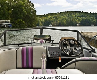 A Ski Boat Tied Up At A Dock Showing The Interior View.