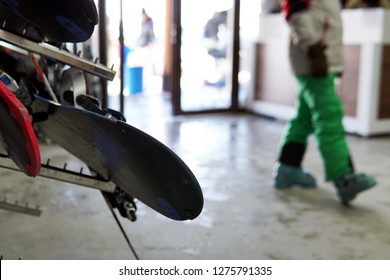 ski equipment rental room, interior, people getting dressed, shelves, boots, snowboards, skis as fun gears for winter sports - Powered by Shutterstock