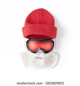 Ski Goggles, Beanie Cap, False Knitted Beard Are On A White Background. Winter Sports Concept. Protection Accessories.  Flat Lay, Top View.