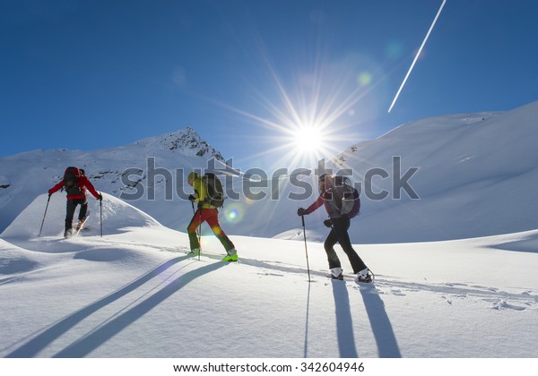ski group starts in the\
morning sun